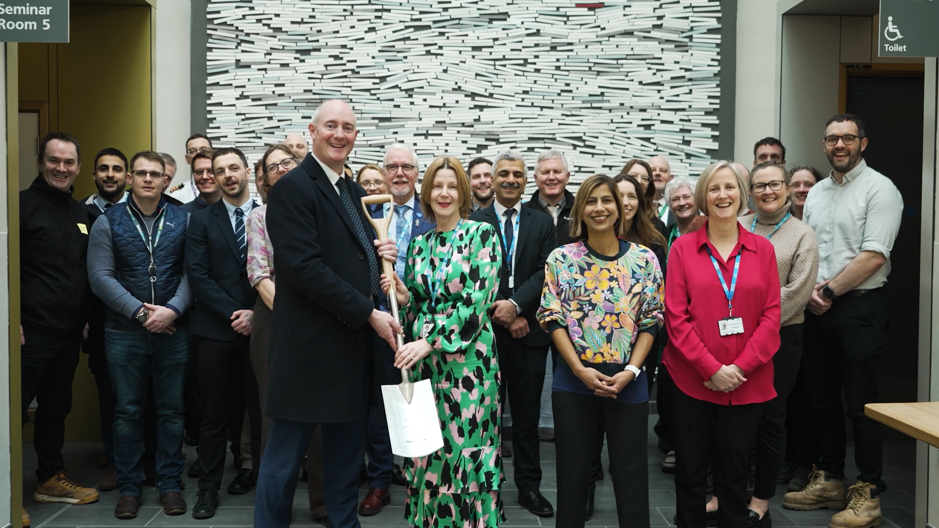 Jim Pierce, the deputy CEO of Darwin Group, handing over a ceremonial ground breaking spade to the team at Southmead Hospital.